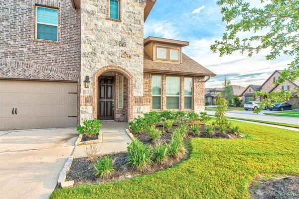 a front view of a house with garden