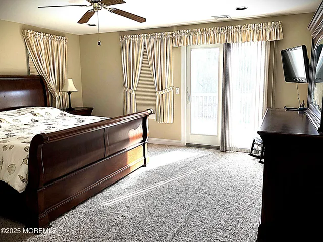 a bedroom with a bed and a flat tv screen