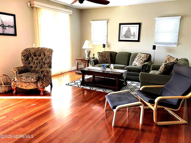 a living room with furniture and a wooden floor