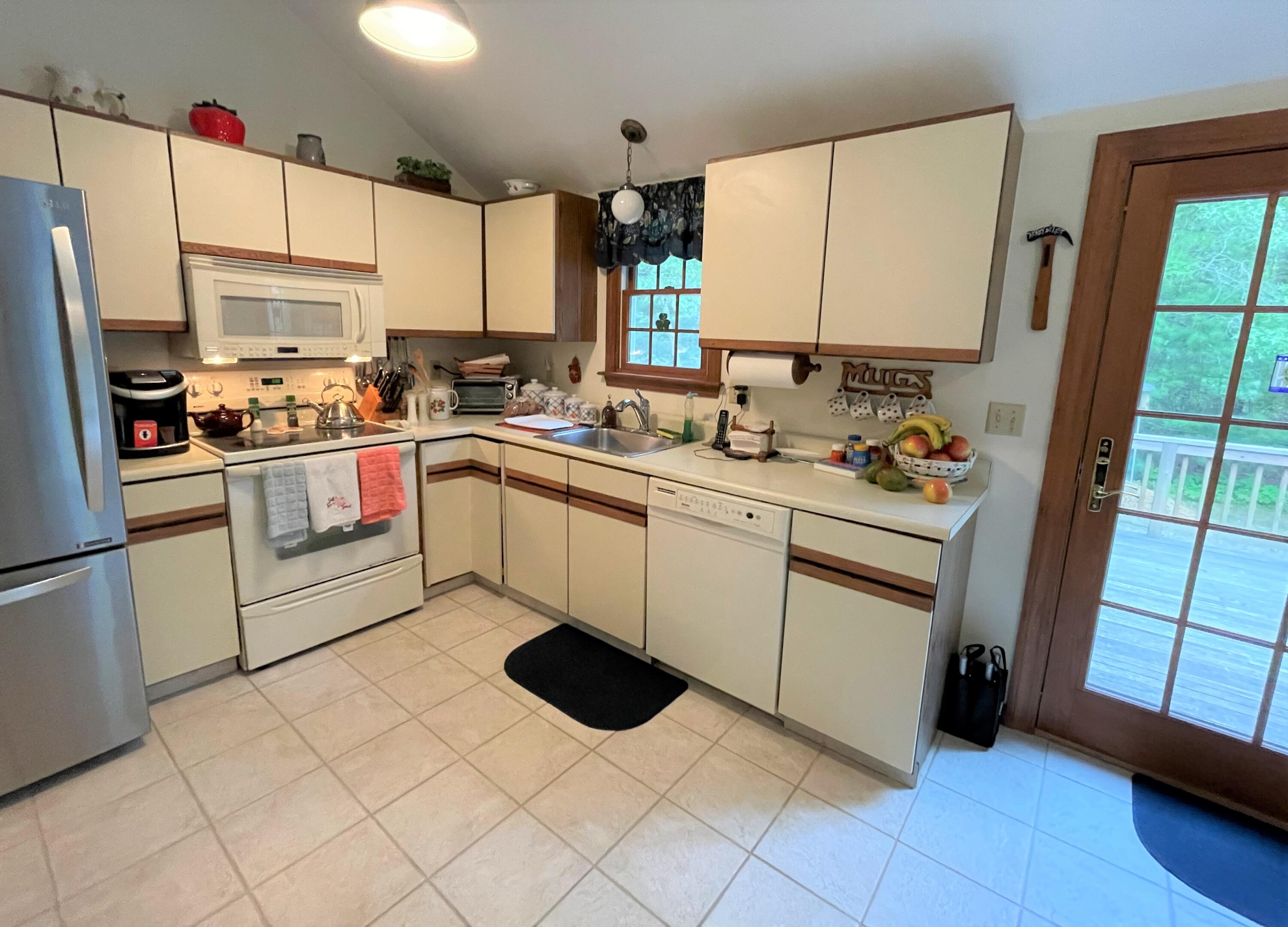 935 Bumps River Road Centerville, MA 02632 - Photo 7 of 14 a kitchen with a sink appliances and cabinets