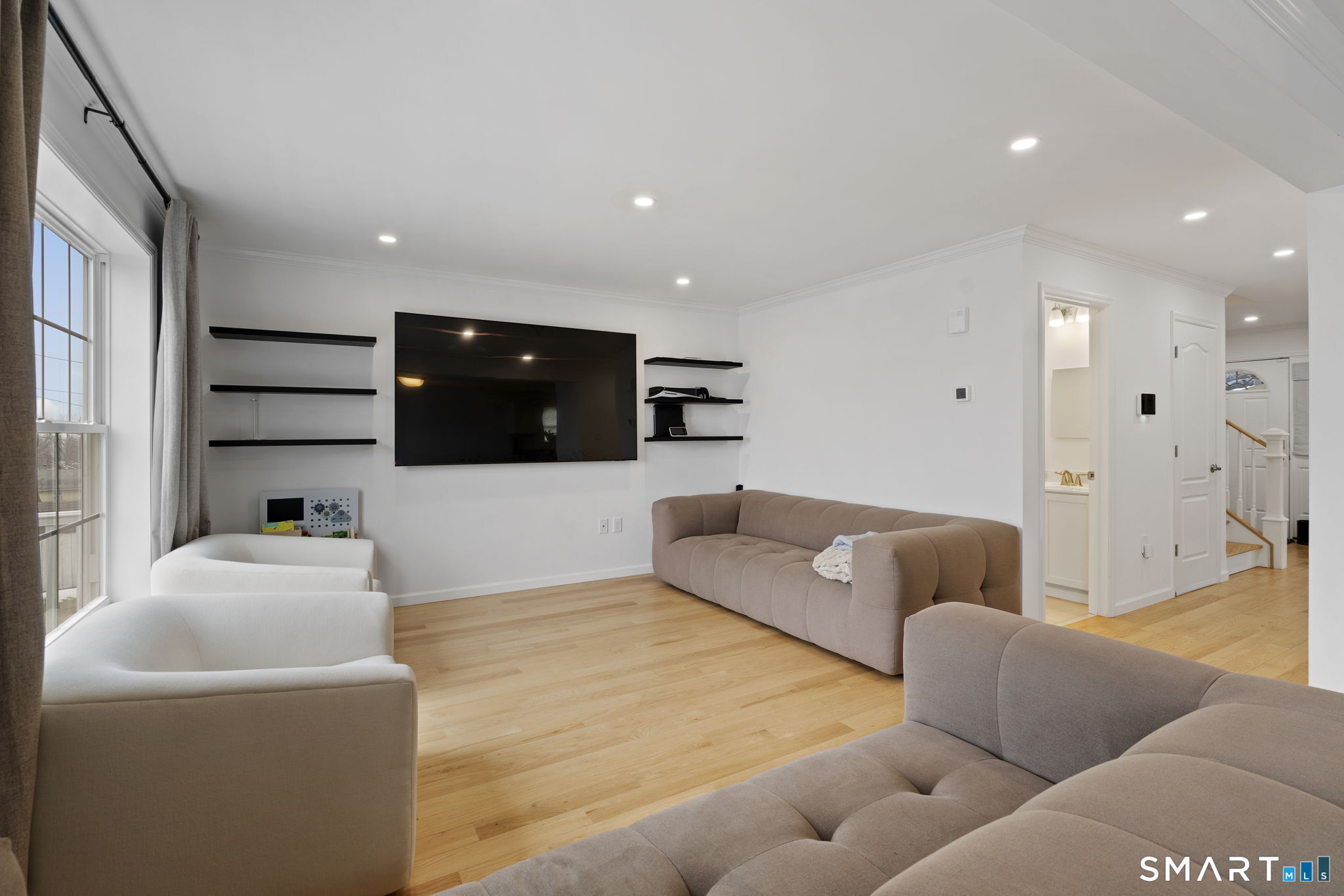a living room with furniture and a flat screen tv