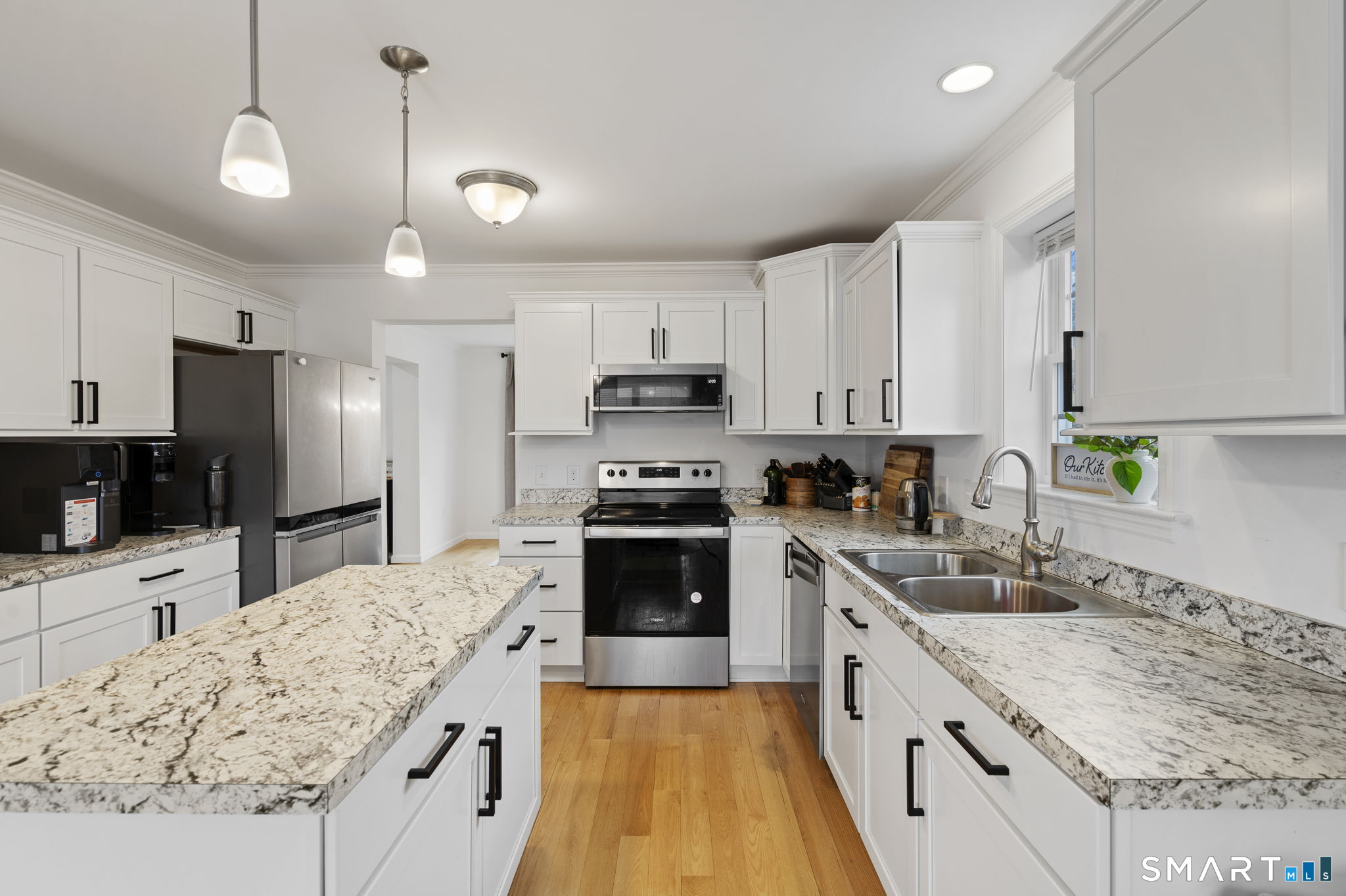156 Dayton Road Bridgeport, CT 06606 - Photo 11 of 28 a large kitchen with granite countertop a sink stainless steel appliances and white cabinets