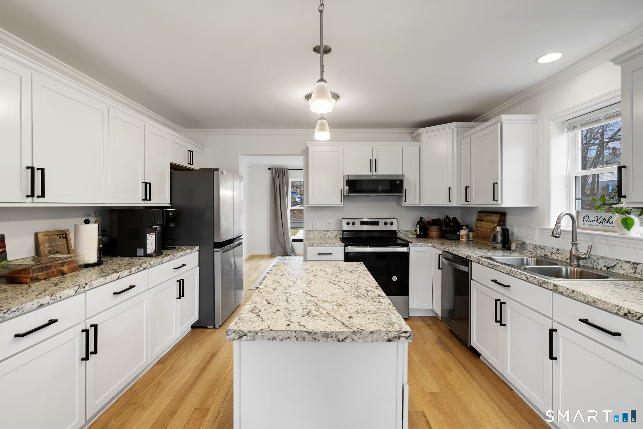 156 Dayton Road Bridgeport, CT 06606 - Photo 6 of 28 a kitchen with granite countertop a sink stainless steel appliances and white cabinets