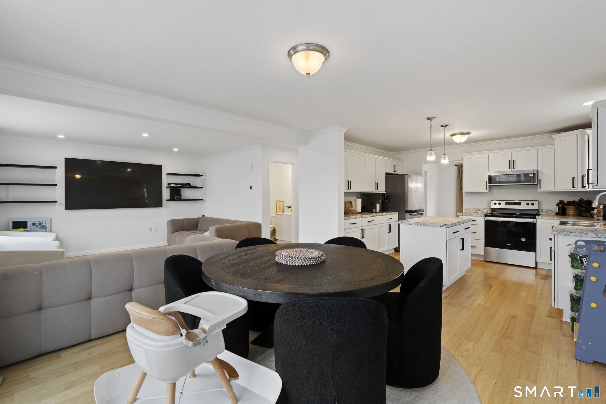 156 Dayton Road Bridgeport, CT 06606 - Photo 7 of 28 a kitchen with a table chairs stove and microwave