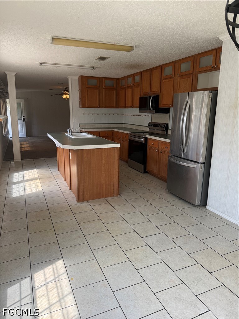 1660 Evans Road LaBelle, FL 33935 - Photo 3 of 10 a kitchen with stainless steel appliances granite countertop a refrigerator and a stove
