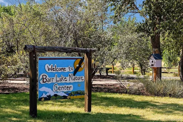 a sign broad in front of the tree
