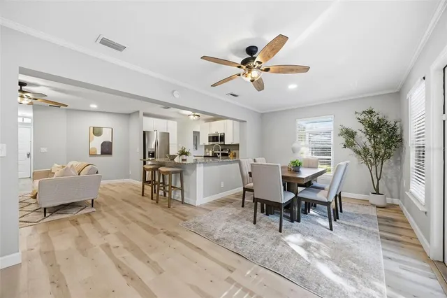 a view of a dining room with furniture and a chandelier