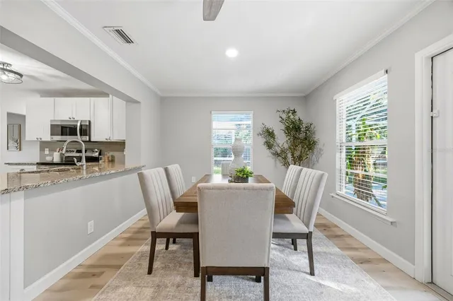 a dining room with furniture and window