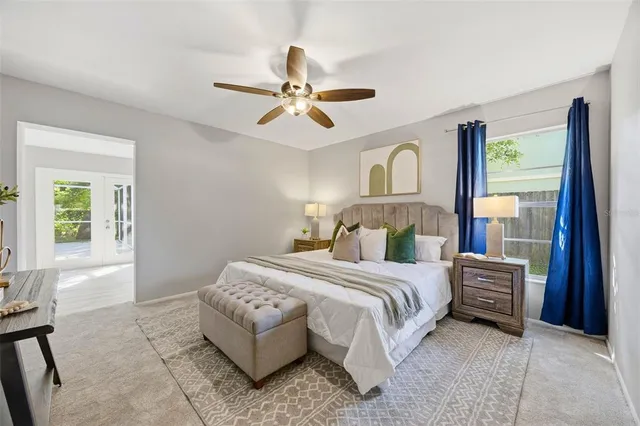 a bedroom with a bed and a chandelier