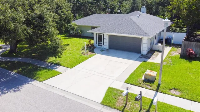 a aerial view of a house with swimming pool garden and patio