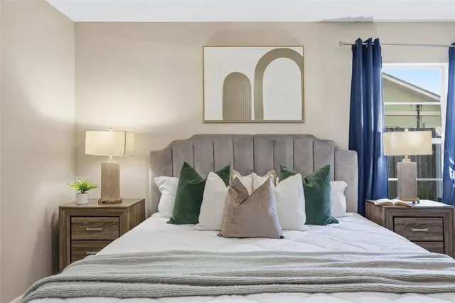 a bedroom with a bed and a large window