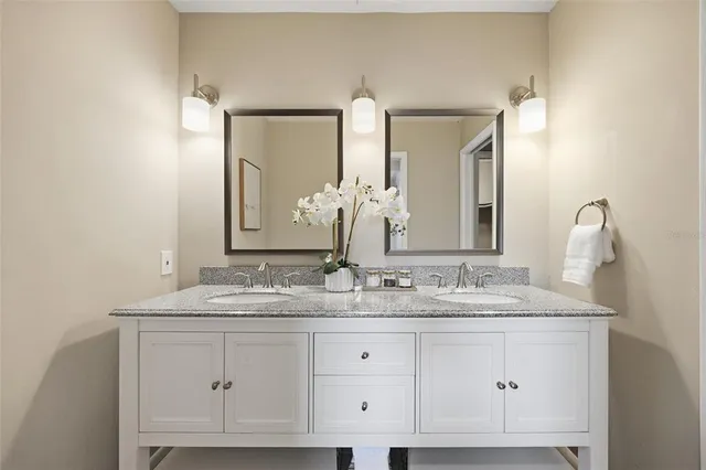 a bathroom with a double vanity sink and a mirror