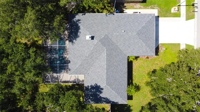 an aerial view of a house with a yard