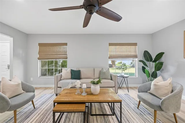 a living room with furniture and a large window