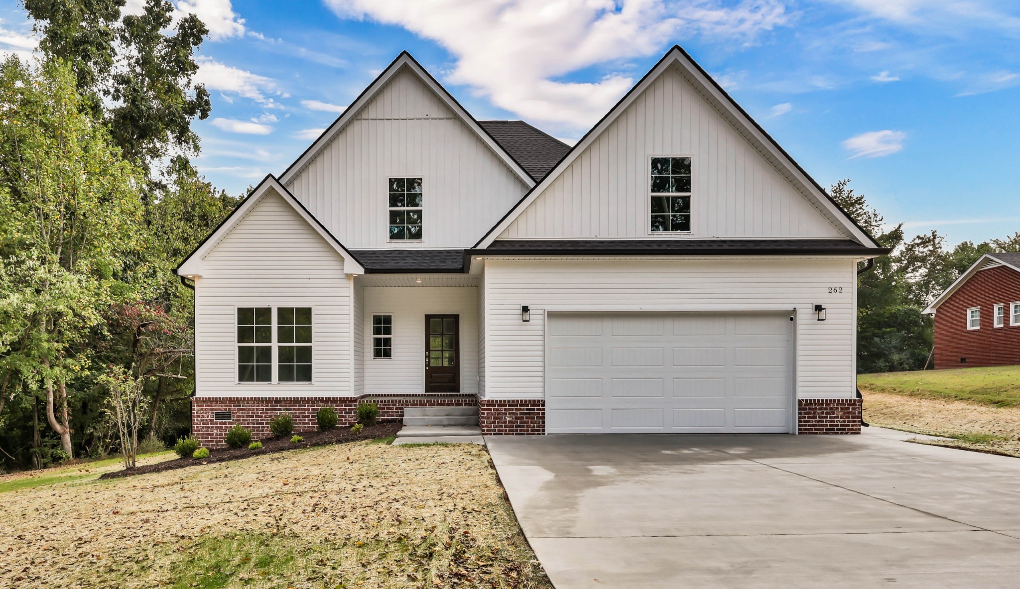 a front view of a house with a yard and garage