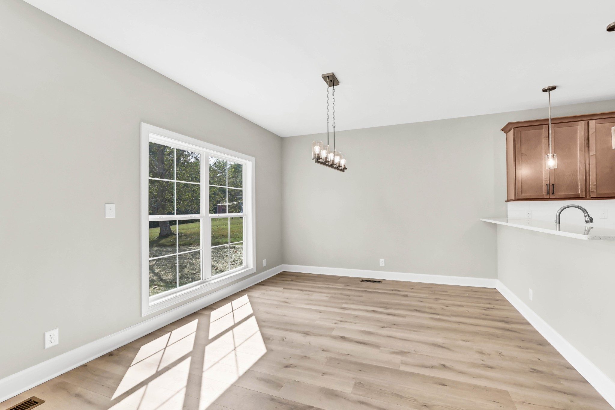 262 Rossview Road Clarksville, TN 37043 - Photo 15 of 43 a view of an empty room with a window and wooden floor