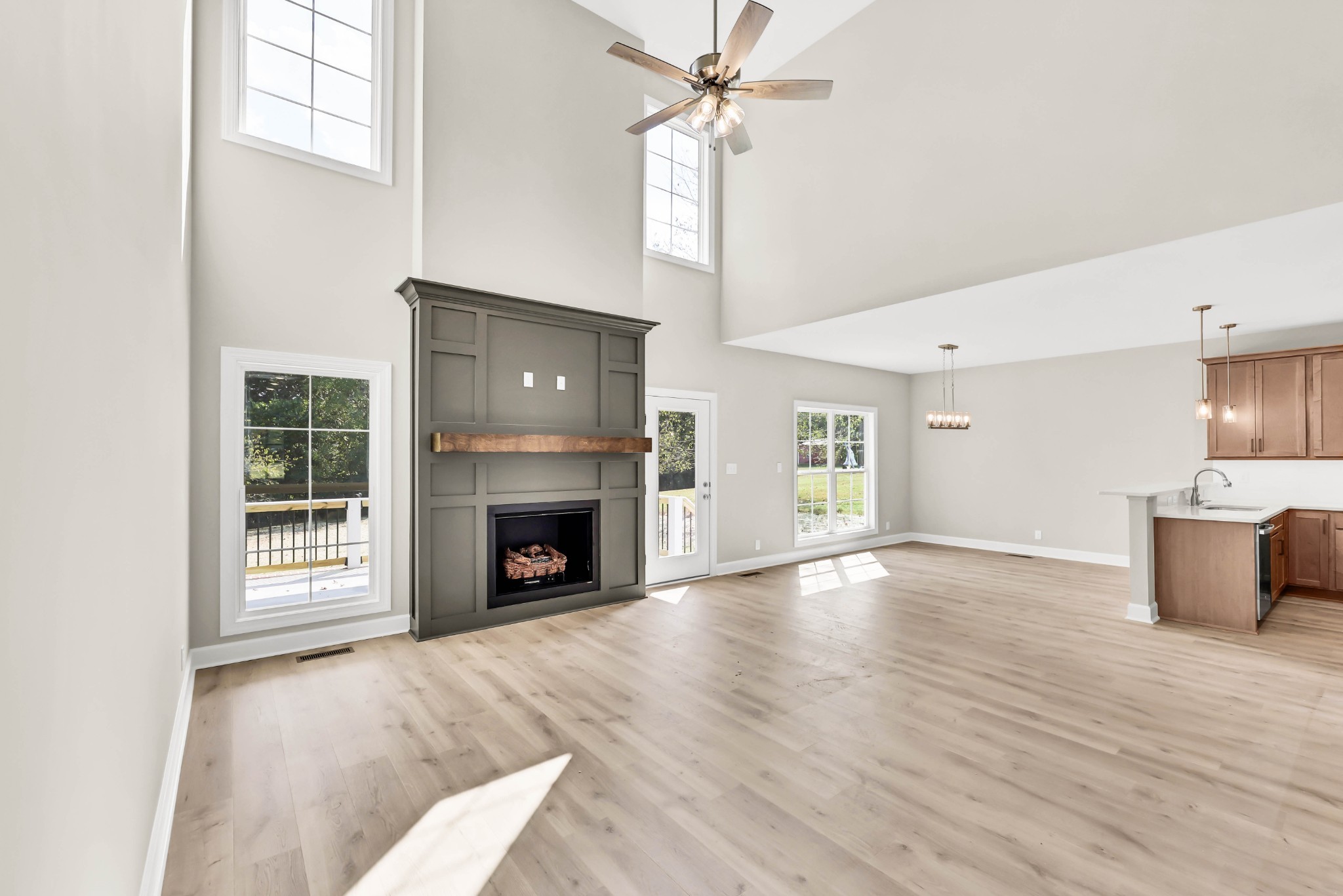 262 Rossview Road Clarksville, TN 37043 - Photo 6 of 43 wooden floor fireplace and windows in an empty room