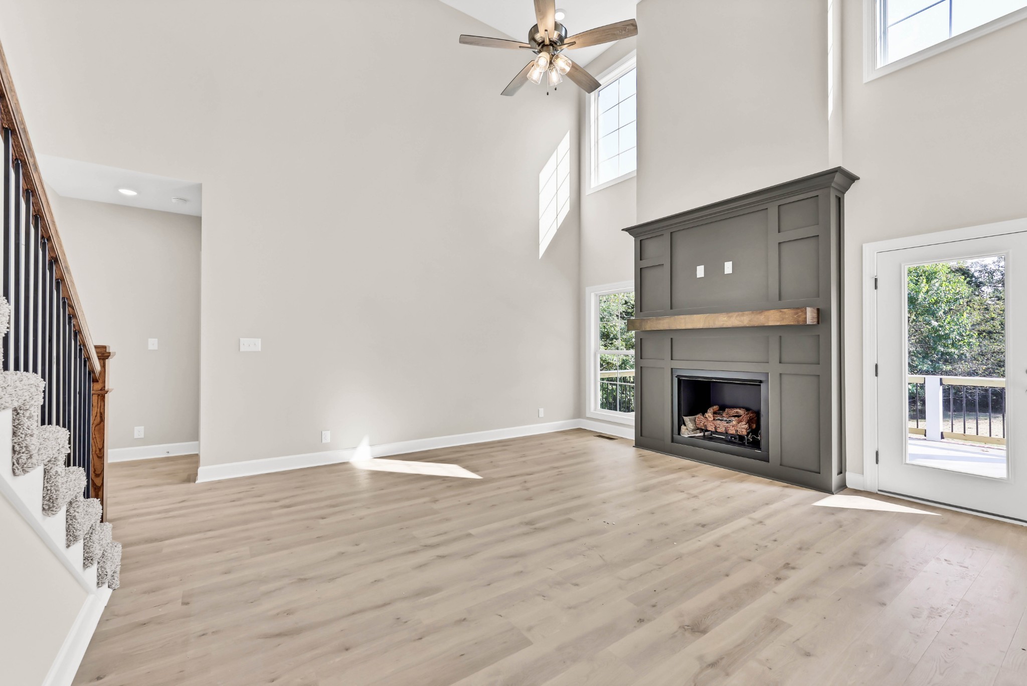 262 Rossview Road Clarksville, TN 37043 - Photo 10 of 43 an empty room with wooden floor a fireplace and windows