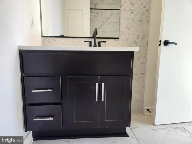 a bathroom with a sink and mirror