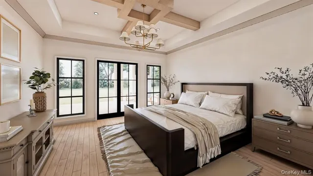 a spacious bedroom with a large bed and a chandelier