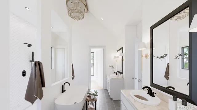 a bathroom with a tub sink and mirror