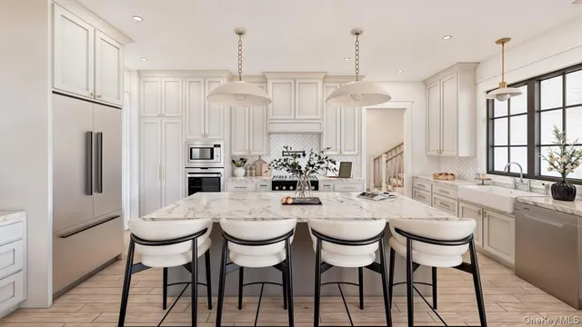 a dining room with stainless steel appliances a table chairs and chandelier