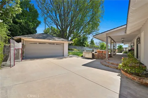 a view of a patio with table and chairs under an umbrella