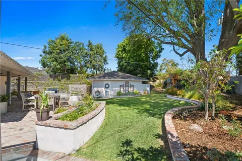 a view of a house with backyard and sitting area