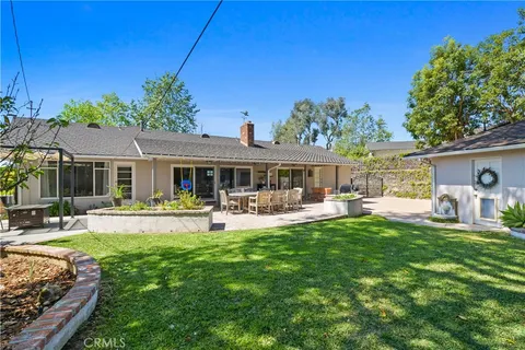 a front view of a house with swimming pool having outdoor seating