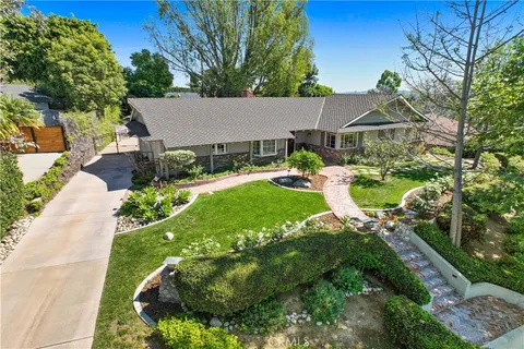 aerial view of a house with yard and green space