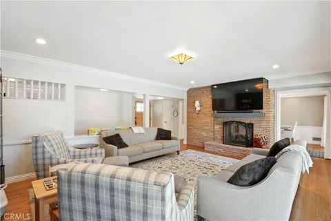 a bedroom with furniture and a flat screen tv