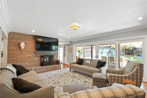 a living room with furniture fireplace and a flat screen tv