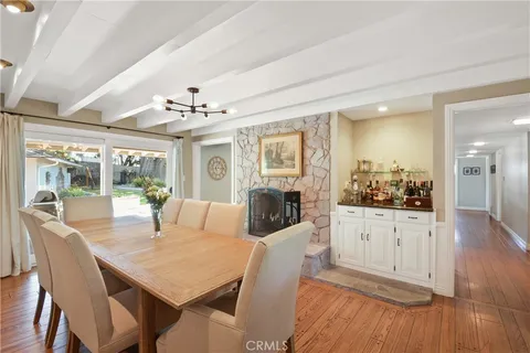 a view of a dining room with furniture wooden floor and chandelier