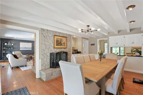 a view of a dining room with furniture wooden floor and chandelier