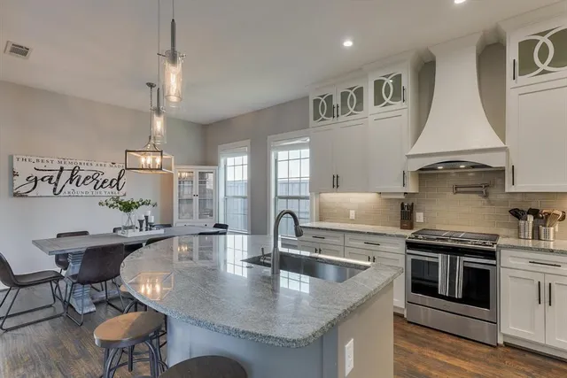 a view of a dining room with furniture a chandelier and wooden floor