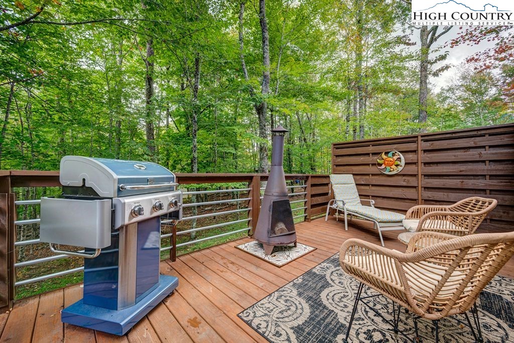 607 Charter Hills Road Beech Mountain, NC 28604 - Photo 21 of 31 a view of a chairs and table on the wooden floor
