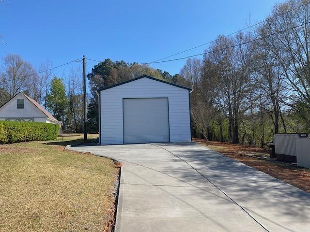 5919 River Road Flowery Branch, GA 30542 - Photo 8 of 18 a front view of a house with a yard and garage