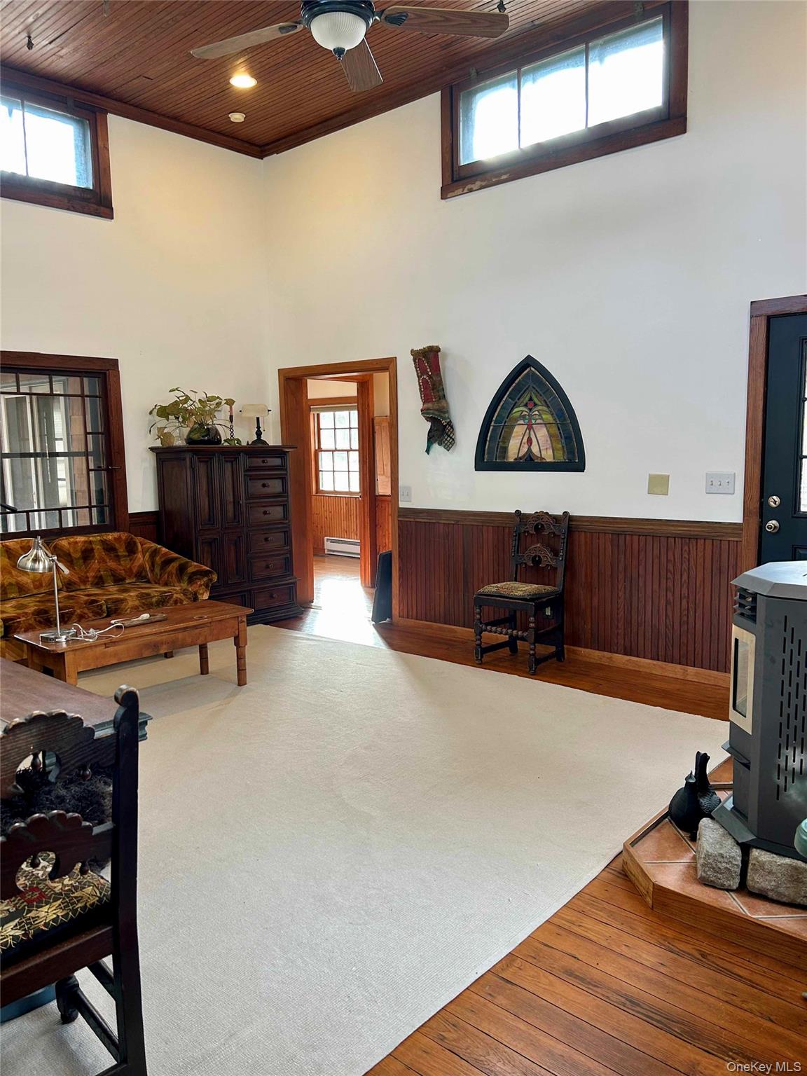 186 Taylor Road Cornwall, NY 10953 - Photo 11 of 26 Carpeted living room with a towering ceiling, pellet stove