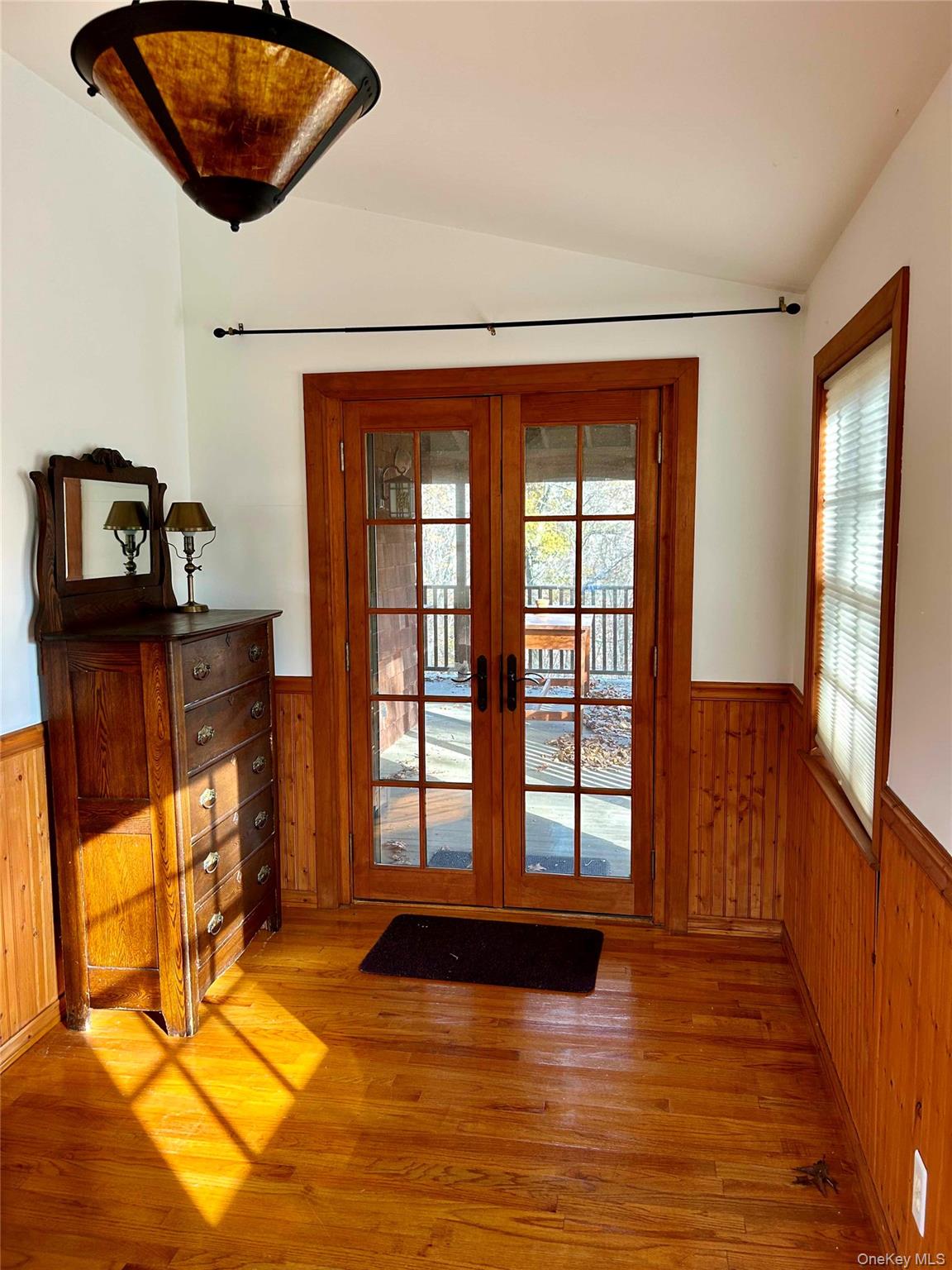 186 Taylor Road Cornwall, NY 10953 - Photo 15 of 26 Bedroom featuring vaulted ceiling, wooden walls, and french doors