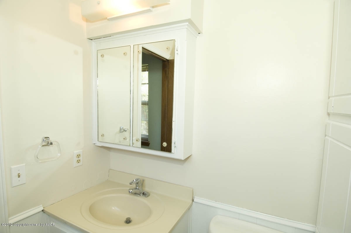 8206 Santa Fe Trail Amarillo, TX 79110 - Photo 17 of 31 a bathroom with a sink and a mirror