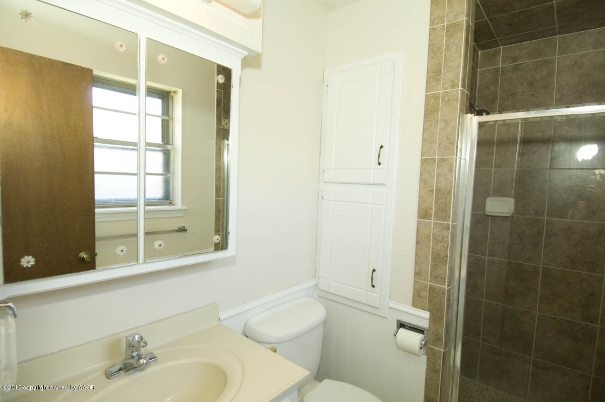 8206 Santa Fe Trail Amarillo, TX 79110 - Photo 18 of 31 a bathroom with a granite countertop bathtub shower sink vanity and toilet
