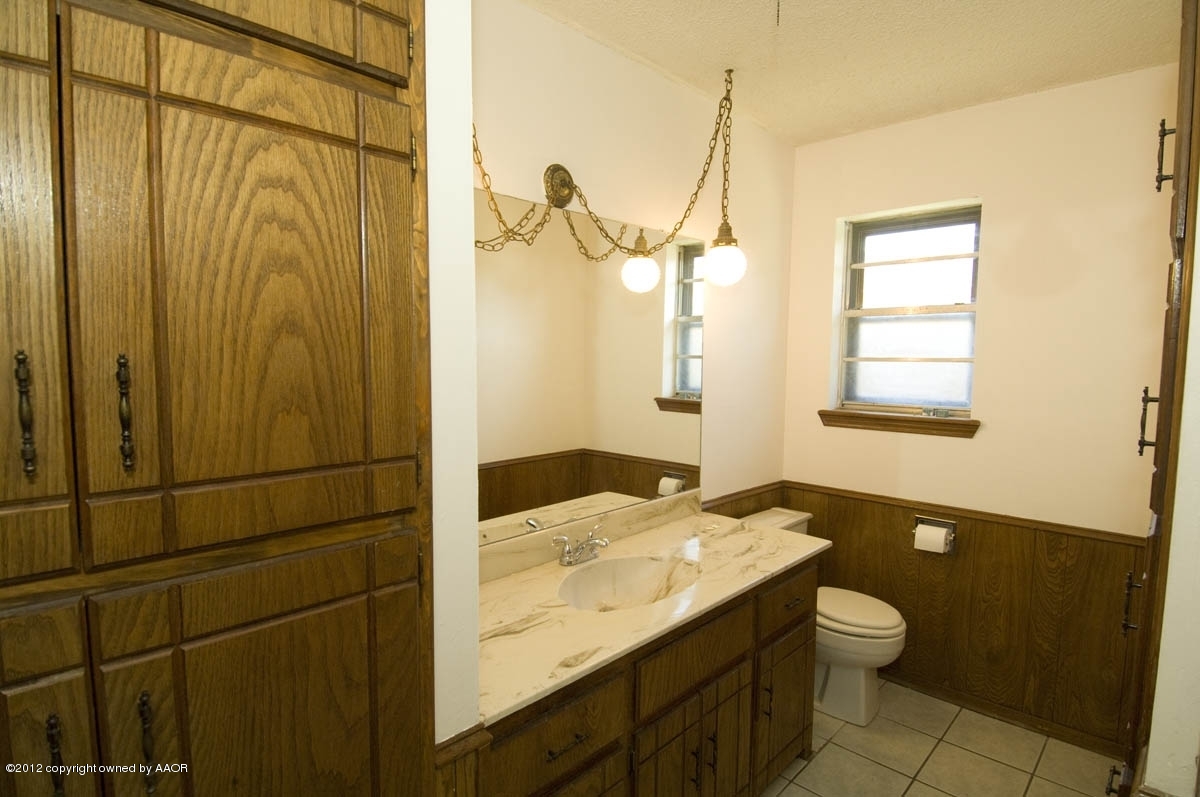8206 Santa Fe Trail Amarillo, TX 79110 - Photo 22 of 31 a bathroom with a granite countertop sink toilet and shower