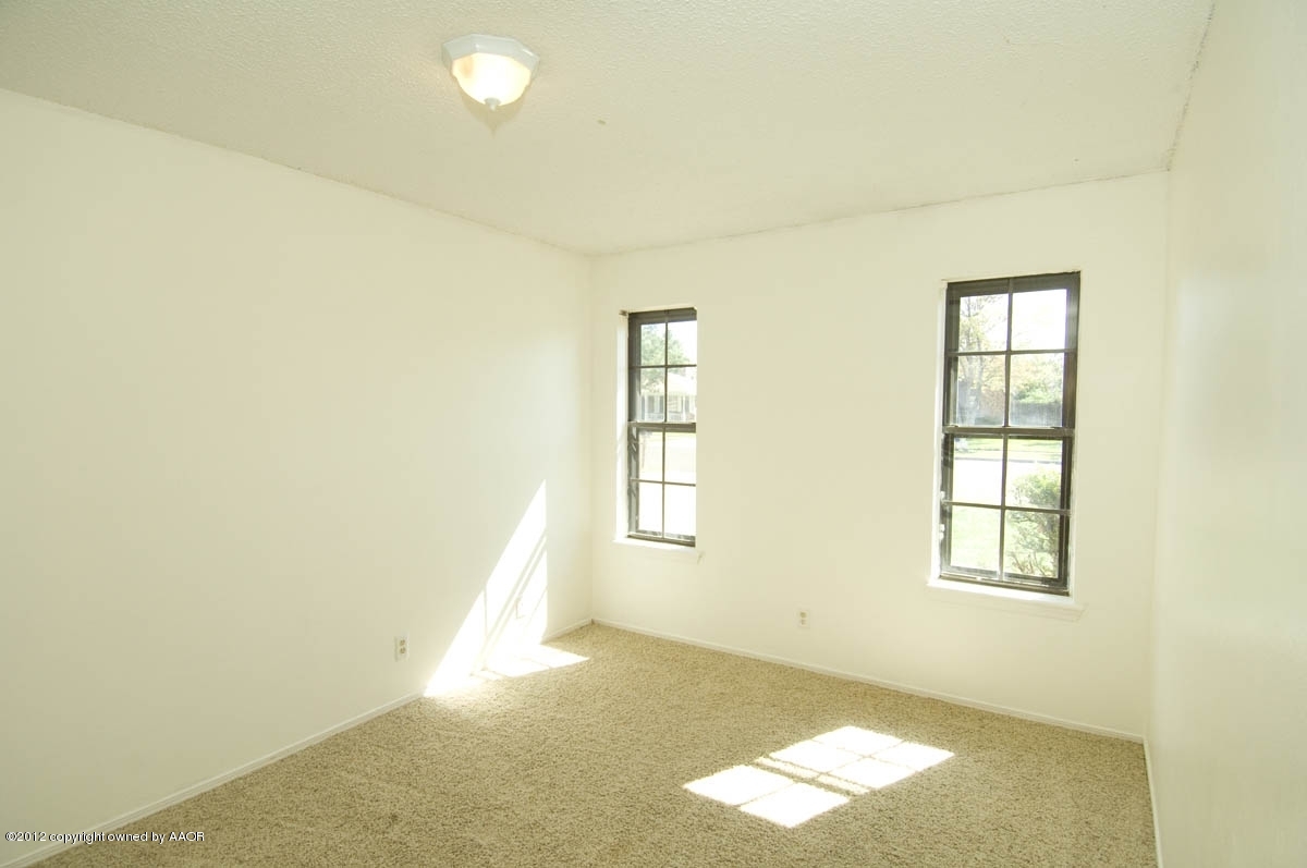 8206 Santa Fe Trail Amarillo, TX 79110 - Photo 24 of 31 an empty room with windows
