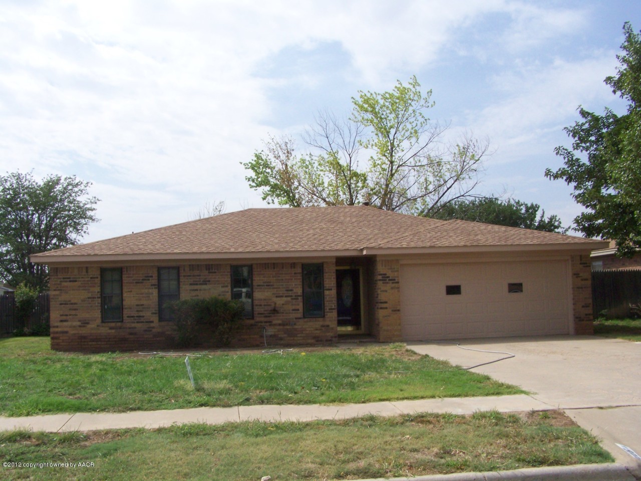 8206 Santa Fe Trail Amarillo, TX 79110 - Photo 3 of 31 a front view of a house with a garden