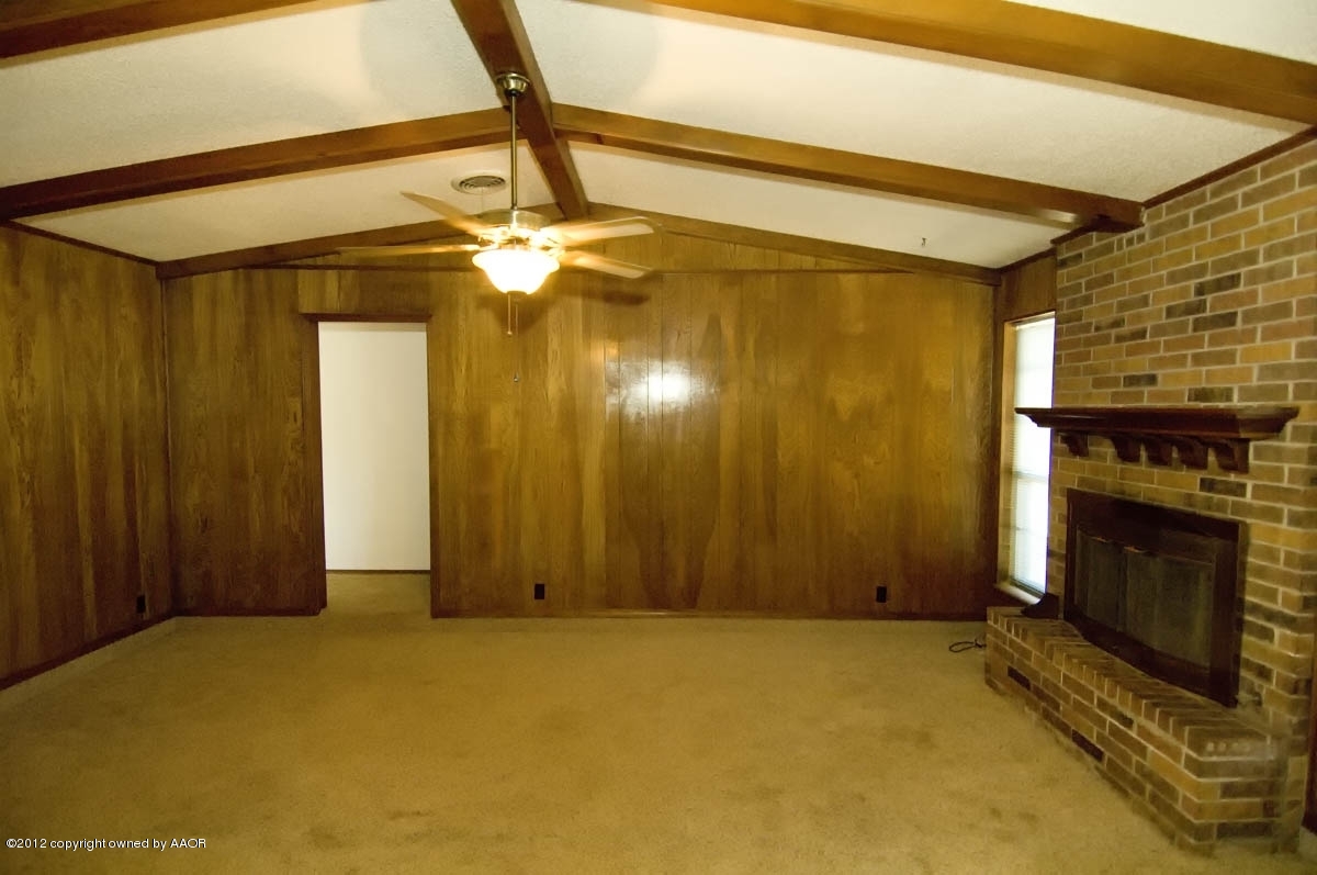 8206 Santa Fe Trail Amarillo, TX 79110 - Photo 5 of 31 a view of an empty room with a fireplace and a window