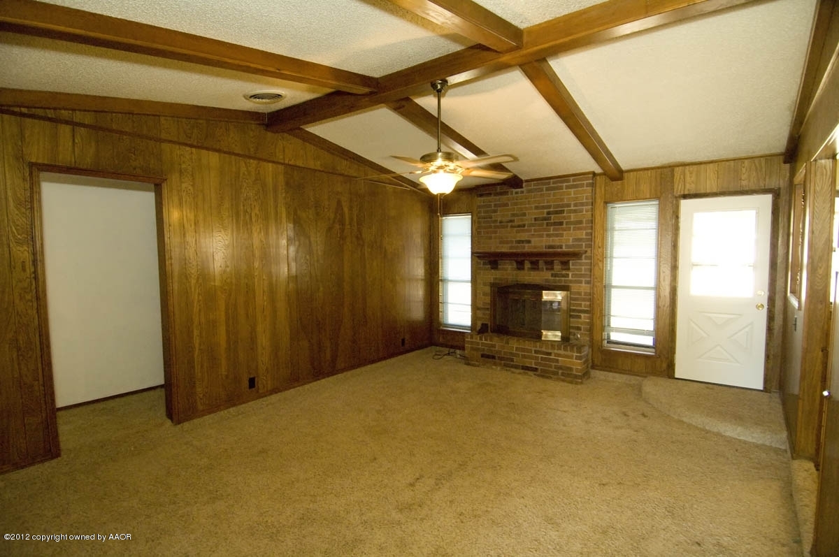 8206 Santa Fe Trail Amarillo, TX 79110 - Photo 7 of 31 a view of an empty room with a fireplace and a window