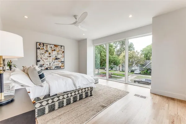 a spacious bedroom with a large bed and a large window