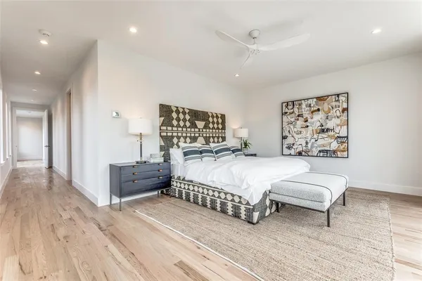 a bedroom with a large bed and a chandelier