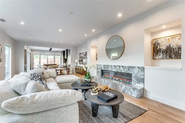 a living room with furniture a fireplace and a wall painting
