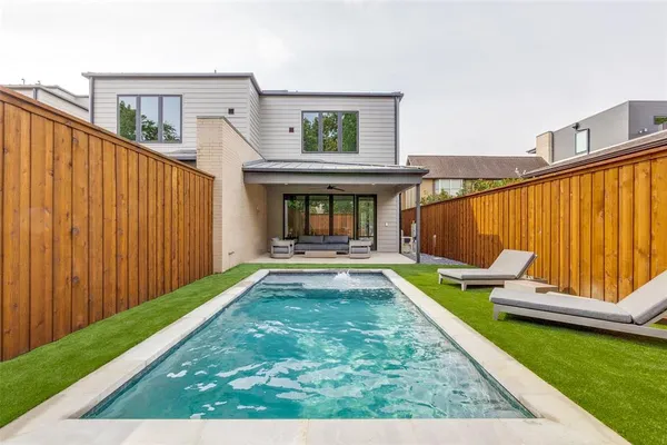 a view of swimming pool with a lounge chairs